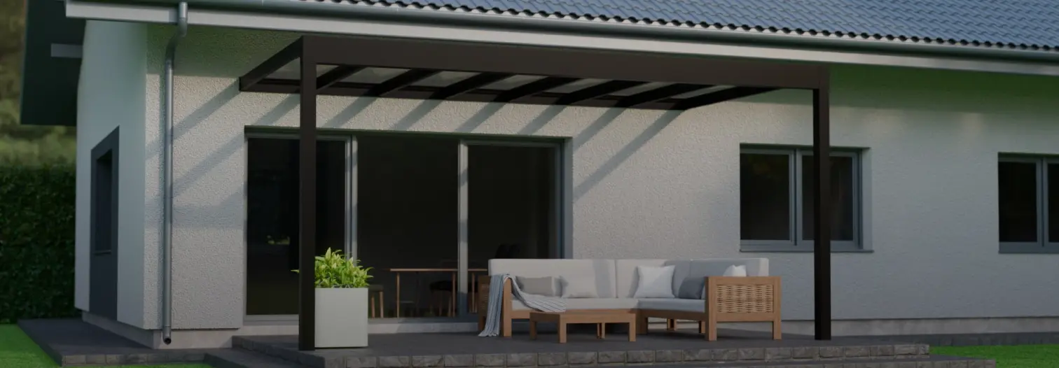 A modern patio with a sleek pergola stands beside a white house. Underneath, a gray sofa with cushions and a coffee table create a cozy outdoor seating area
