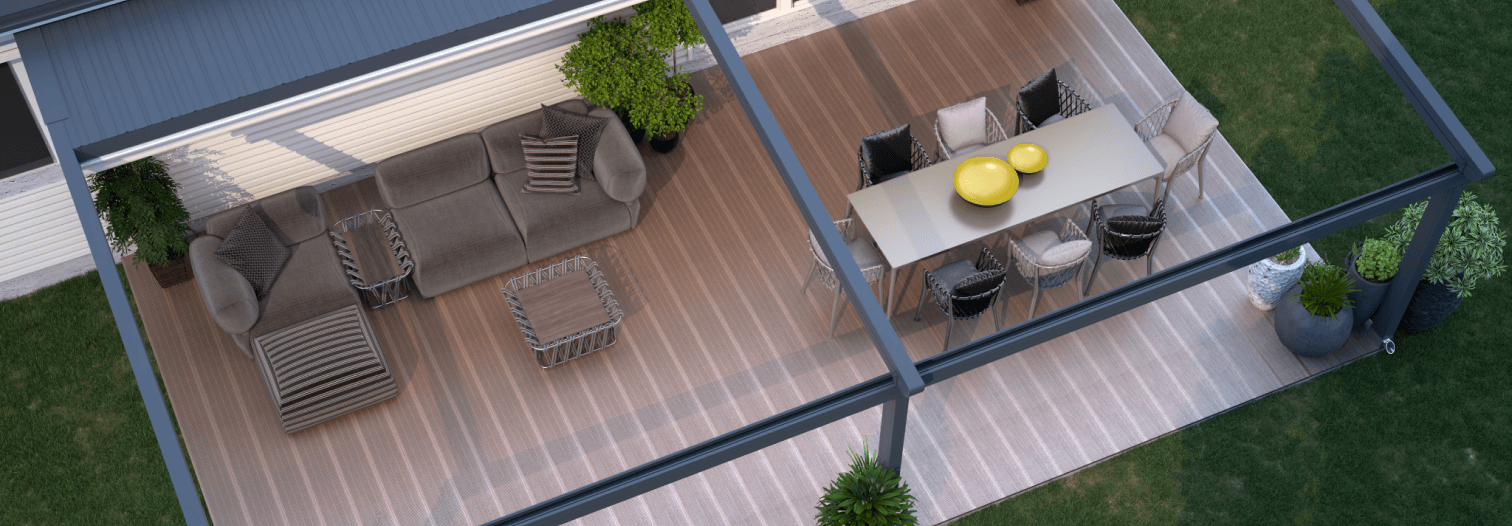 Aerial view of a modern patio with a brown sectional sofa, striped cushions, a rectangular dining table with yellow accents, and green plants, creating a cozy outdoor space