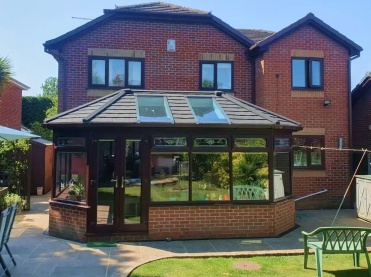 Conservatory extension with modern tiled roof improving home value and energy efficiency