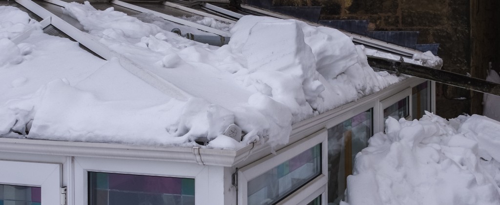 Snow sitting on a conservatory roof showing poor insulation and heat loss